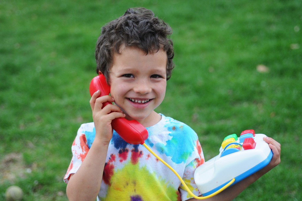 Boy calling on toy phone
