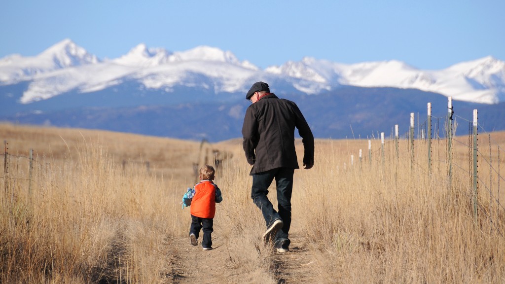 Father and son running towards mountains